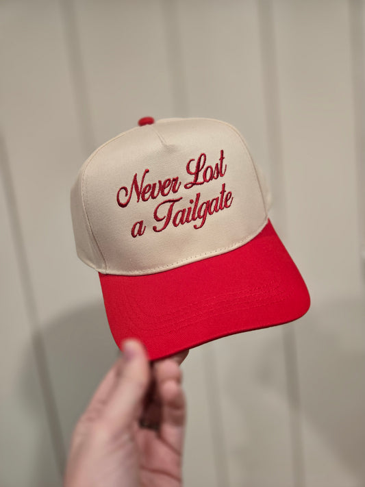 NEVER LOST A TAILGATE Embroidered Red/Beige Trucker Hat