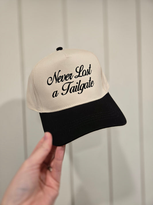 NEVER LOST A TAILGATE Embroidered Black/Beige Trucker Hat